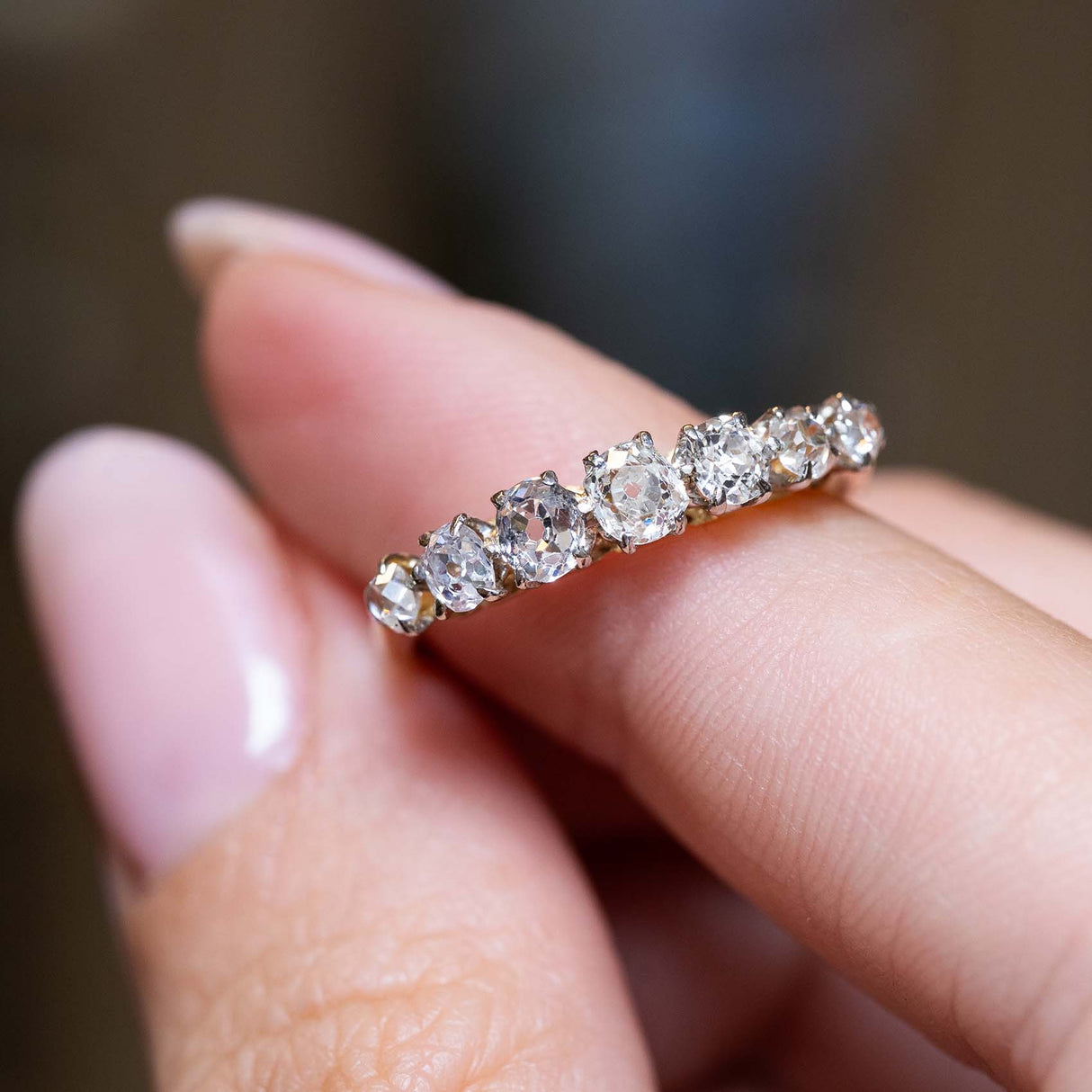 Close-up of seven graduated antique diamonds in a curved row