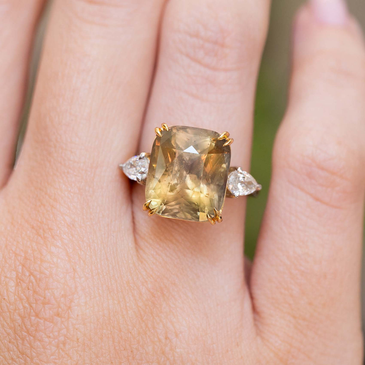 Brown sapphire and diamond cocktail ring worn on the finger