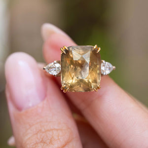 Close-up of a large cushion-cut brown sapphire with pear-shaped diamonds