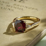 3ct cushion ruby and diamond three stone engagement ring in classic yellow gold setting