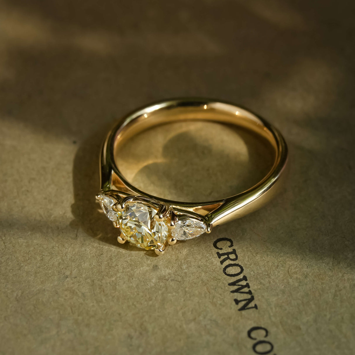 Champagne diamond and diamond three stone engagement ring in classic yellow gold setting