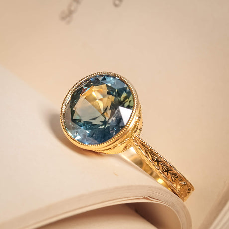 5.70ct blue green sapphire solitaire ring with round gemstone in gold