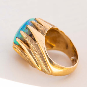 Gallery view of a vintage 1970s cabochon Australian opal ring in yellow gold.