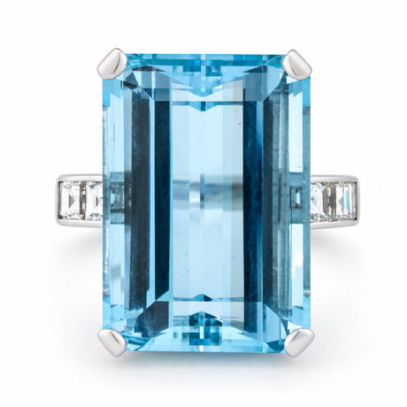 Vintage 1970s aquamarine and diamond cocktail ring in white gold, featuring a large rectangular emerald-cut blue aquamarine with diamond-set shoulders.