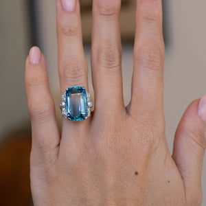 Antique aquamarine and diamond statement ring worn on a hand, showcasing its bold proportions and geometric Art Deco design.