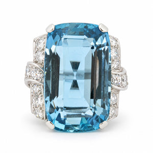 Antique Art Deco aquamarine and diamond cocktail ring in platinum, featuring a large rectangular step-cut aquamarine and diamond-set shoulders.