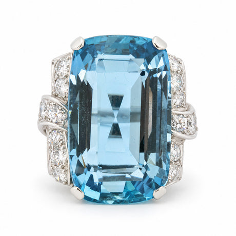 Antique Art Deco aquamarine and diamond cocktail ring in platinum, featuring a large rectangular step-cut aquamarine and diamond-set shoulders.
