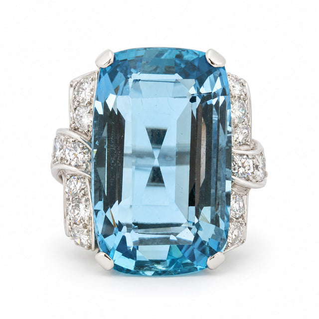 Antique Art Deco aquamarine and diamond cocktail ring in platinum, featuring a large rectangular step-cut aquamarine and diamond-set shoulders.