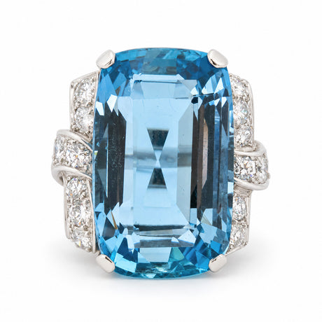 Antique Art Deco aquamarine and diamond cocktail ring in platinum, featuring a large rectangular step-cut aquamarine and diamond-set shoulders.