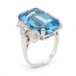 Angled view of the Art Deco aquamarine ring, highlighting the geometric diamond detailing and polished platinum setting.