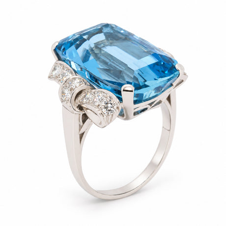 Angled view of the Art Deco aquamarine ring, highlighting the geometric diamond detailing and polished platinum setting.