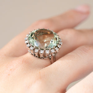 The vintage gemstone ring photographed at an angle on a hand, displaying its raised setting and large quartz.