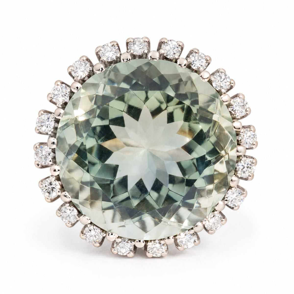 Vintage green quartz and diamond cluster ring in white gold, featuring a large oval green gemstone encircled by sparkling diamonds.