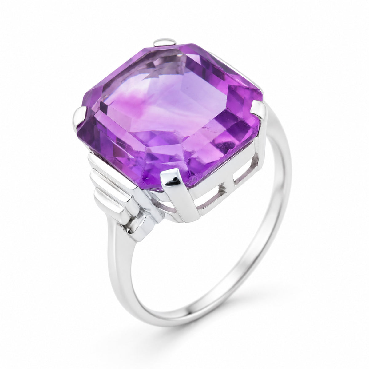 Angled view of the Art Deco amethyst ring, highlighting the raised claw setting, polished white gold and architectural shoulder detailing.