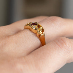 Side-angled view of the Edwardian ring being worn, revealing its gently raised stones and substantial gold shank.