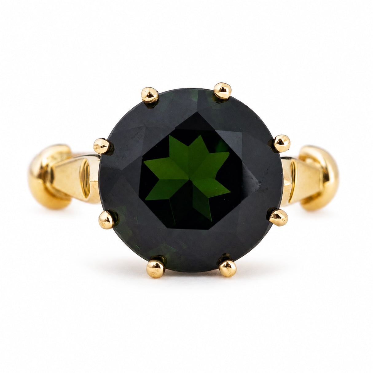A Vintage, 1980's green tourmaline solitaire cocktail ring in yellow gold, photographed on a white background.