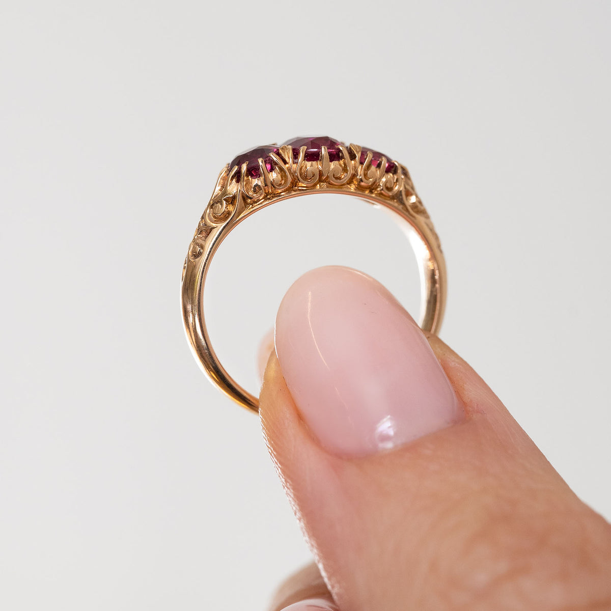 Reverse profile of the Edwardian three-stone ring, showing its open gallery and slender yellow gold band.