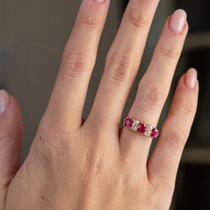 Antique Burmese ruby five-stone ring worn on the hand, displaying its bold linear design and warm yellow gold setting.