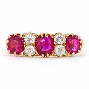 Antique Edwardian Burmese ruby and old-cut diamond five-stone engagement ring in yellow gold, with alternating vivid rubies and bright diamonds.
