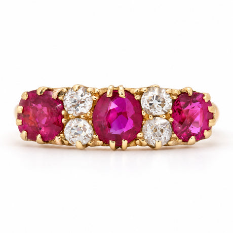 Antique Edwardian Burmese ruby and old-cut diamond five-stone engagement ring in yellow gold, with alternating vivid rubies and bright diamonds.