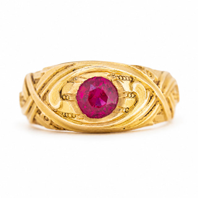 Antique Art Nouveau era natural red ruby single-stone ring in yellow gold against white background