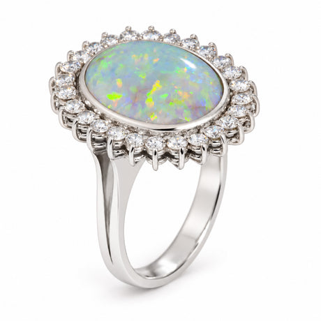 Angled photograph of the opal cocktail ring, showcasing its colourful gemstone, diamond halo and polished white gold setting.