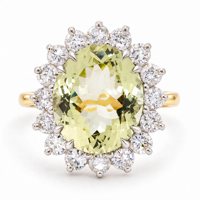 A Vintage, 1960s Green beryl and diamond cluster engagement ring on a yellow gold band white background.