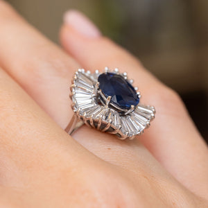 Side view of a vintage sapphire and baguette diamond cocktail ring, revealing the sculptural raised setting in 18ct white gold.