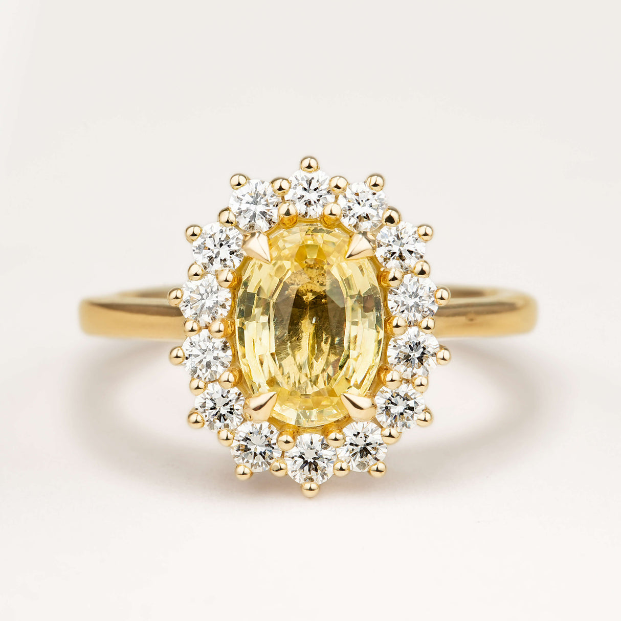 Sri Lankan yellow sapphire and diamond cluster engagement ring
