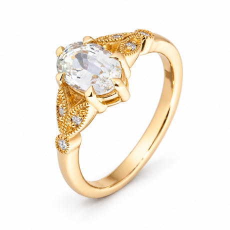 Sculptural studio view of the white sapphire ring, revealing its raised claw setting and delicate diamond accents.