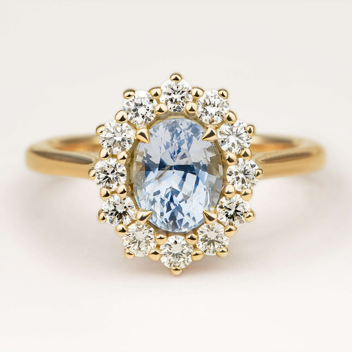 Cornflower blue sapphire and diamond cluster engagement ring
