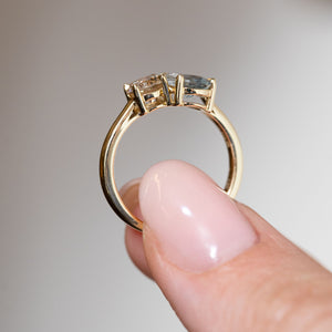 Side profile of the two-stone engagement ring, revealing the open claw settings and polished yellow gold band.