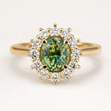 Oval-cut Green sapphire and diamond cluster engagement ring