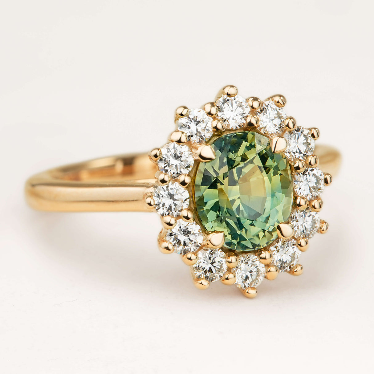 Oval-cut Green sapphire and diamond cluster engagement ring