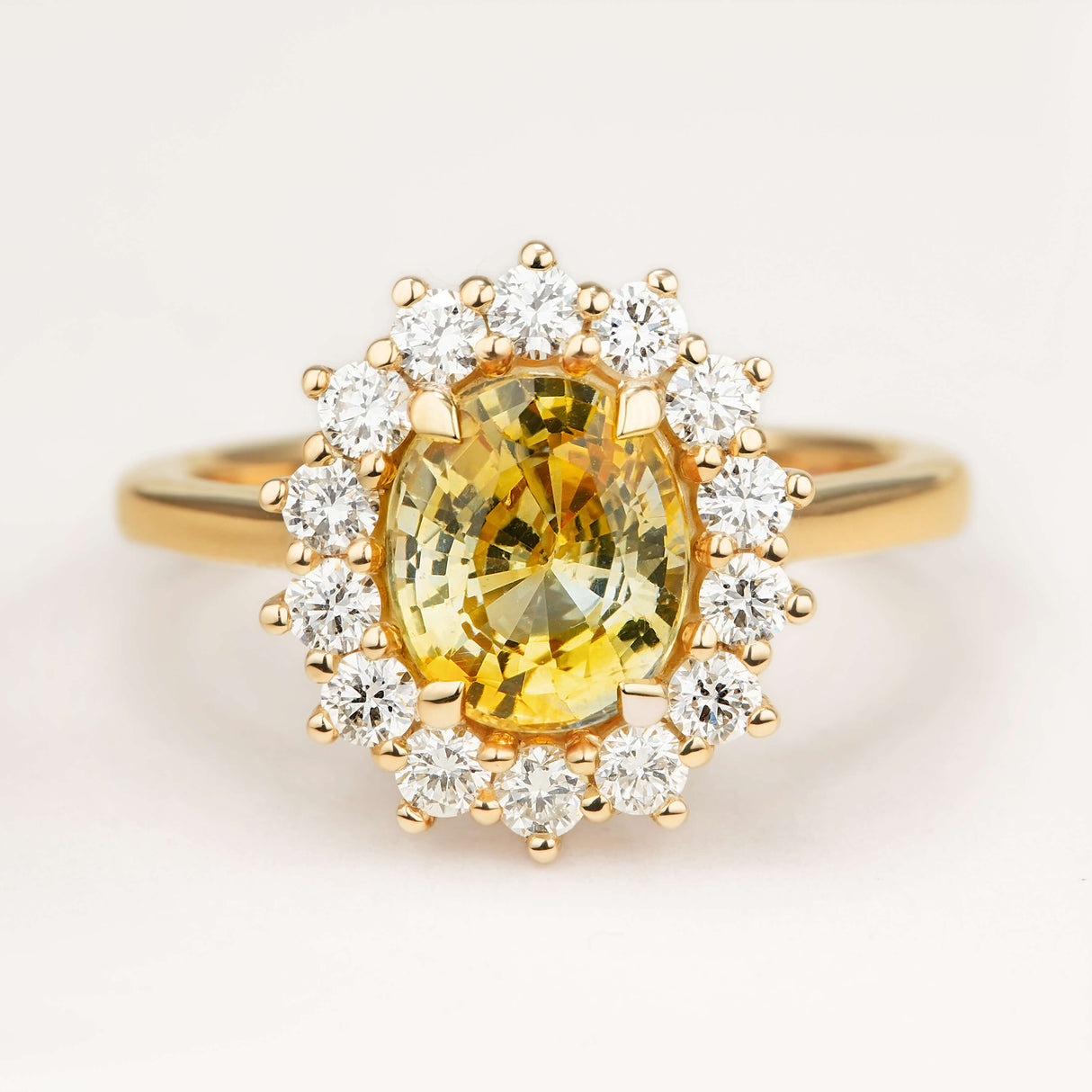 2.11ct oval-cut yellow sapphire and diamond cluster engagement ring