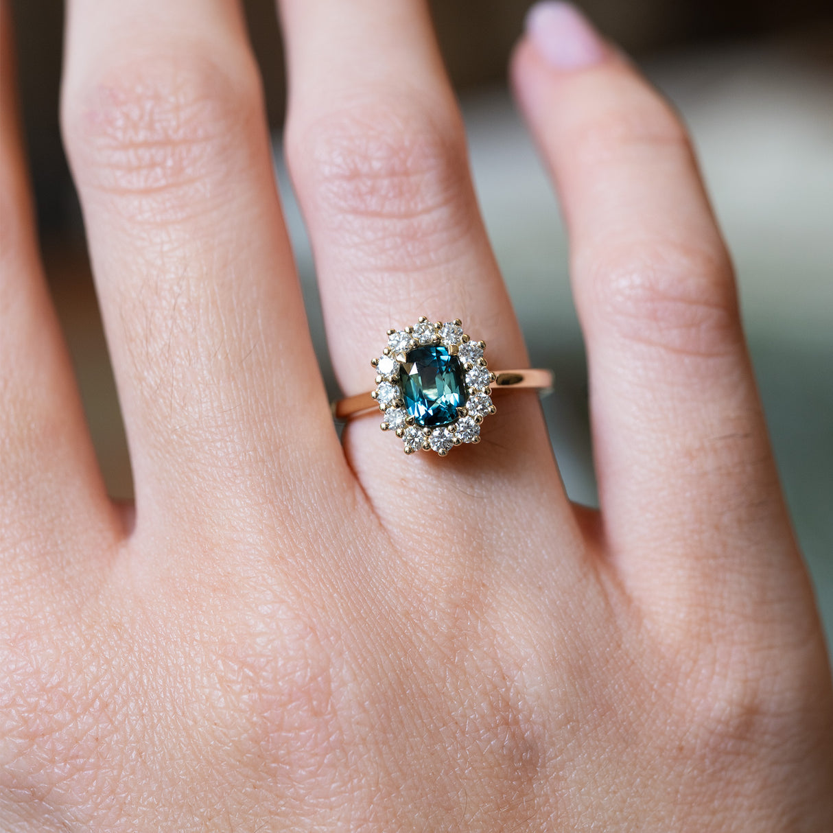 Green sapphire and diamond cluster engagement ring