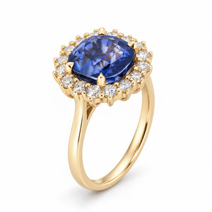 Three-quarter view of an antique-inspired sapphire cluster ring, highlighting its raised setting and delicate gold band.