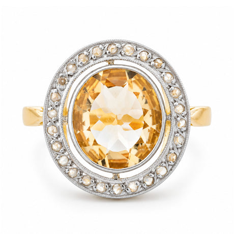 Front view of an antique French Belle Époque yellow citrine and rose-cut diamond cluster engagement ring in yellow gold and platinum.
