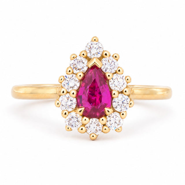 Vintage-inspired pear-cut ruby and diamond cluster engagement ring in polished yellow gold. 