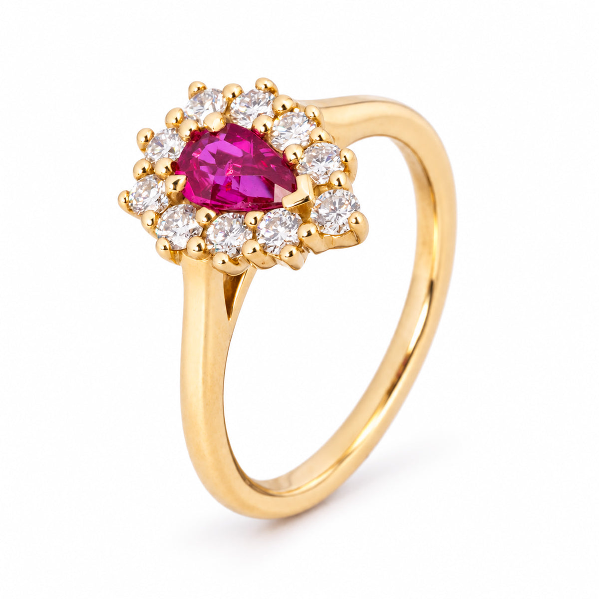 Sculptural view of the pear-shaped ruby cluster ring, showcasing its diamond halo and slender yellow gold band.