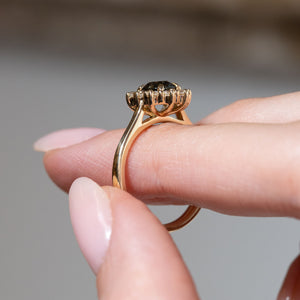Side profile of the sapphire and diamond cluster ring, revealing the raised gallery and polished yellow gold band.