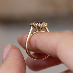 Side profile of the antique-inspired pink sapphire cluster ring, revealing the openwork gallery and polished yellow gold band.