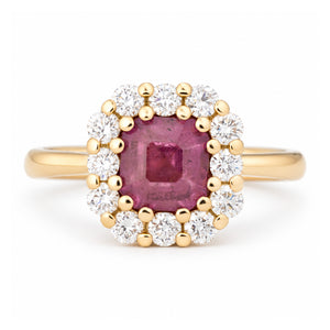 Antique-inspired step-cut pink sapphire and diamond cluster engagement ring in yellow gold, surrounded by a halo of brilliant-cut white diamonds.