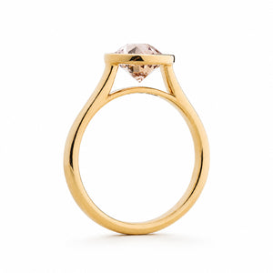 Antique-inspired, peach sapphire solitaire engagement ring