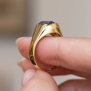 Side view of the yellow gold sapphire ring, revealing its gently elevated setting and smoothly tapered shoulders.