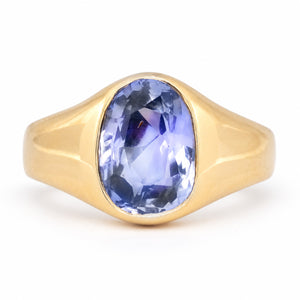 Antique Victorian Ceylon blue-violet sapphire solitaire engagement ring, rub-over set in sculpted yellow gold.