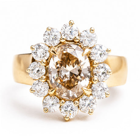 Vintage 1980s fancy coloured brown diamond cluster ring featuring an oval brown diamond surrounded by a sparkling cluster of brilliant-cut white diamonds in yellow gold.