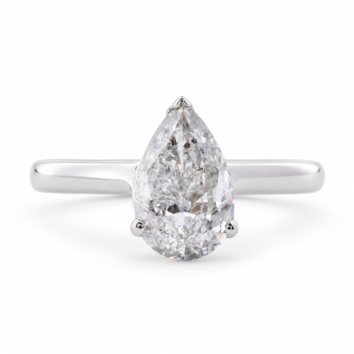 Front view of a vintage 1990s salt and pepper pear-cut diamond solitaire ring in polished white gold.