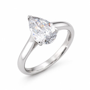 Angled product view of a vintage pear-shaped diamond engagement ring, featuring natural salt and pepper inclusions in a white gold setting.