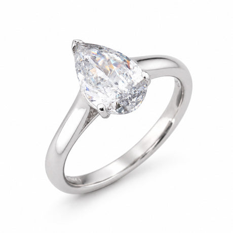 Angled product view of a vintage pear-shaped diamond engagement ring, featuring natural salt and pepper inclusions in a white gold setting.